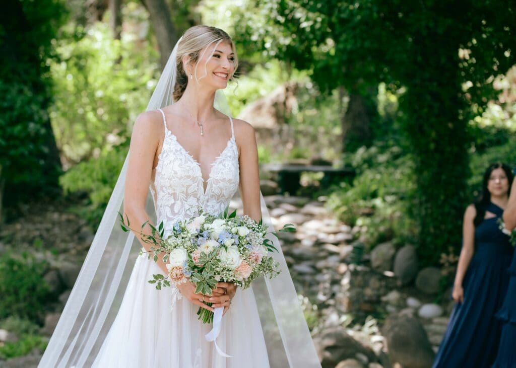 Portrait of bride holding a bouquet and smiling off to the side