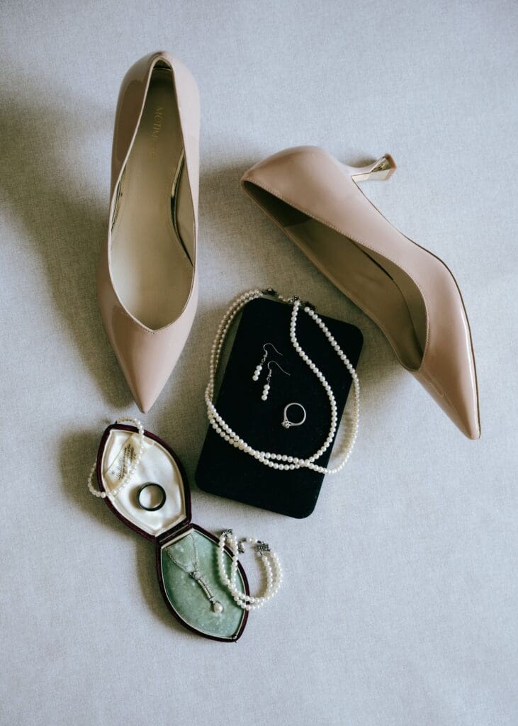 Flat lay shot of bride's shoes and jewelry