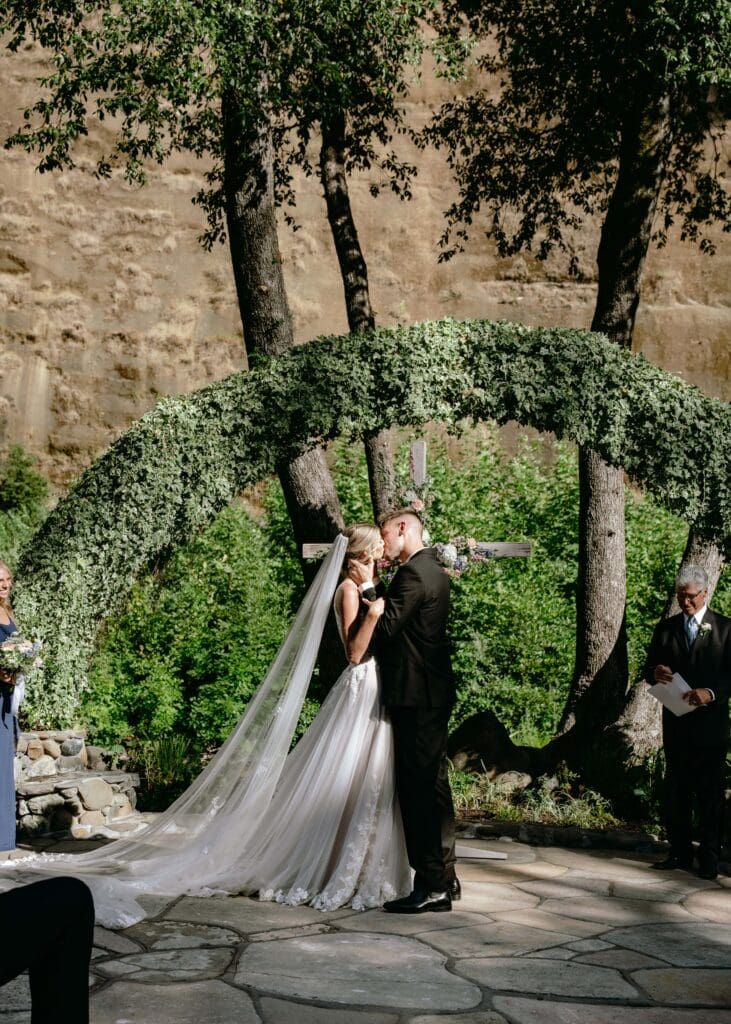 First kiss at the end of elegant summer wedding ceremony at Centerville Estates