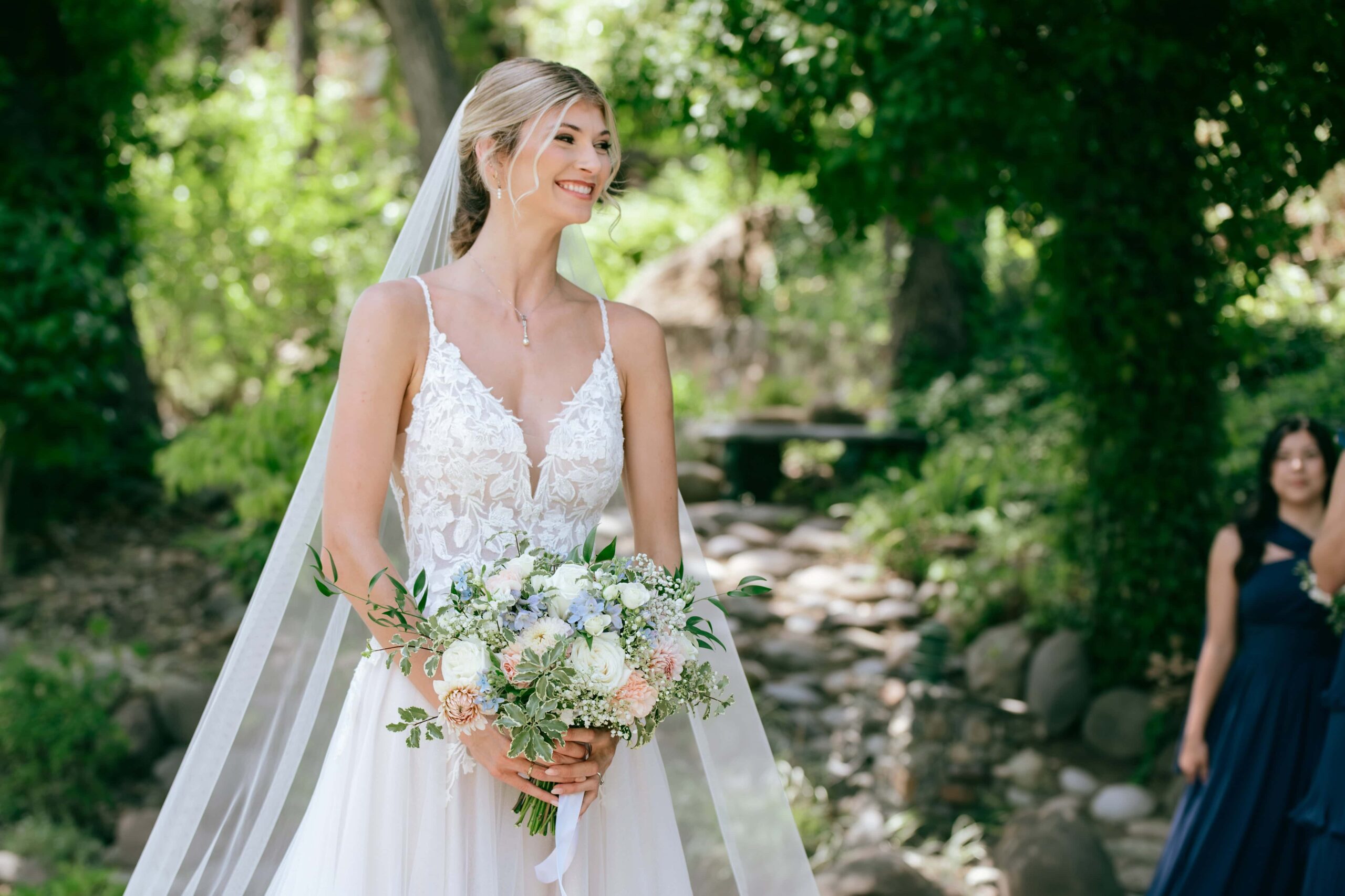 Portrait of bride holding a bouquet and smiling off to the side